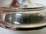 a silver plate with a clock on top of it