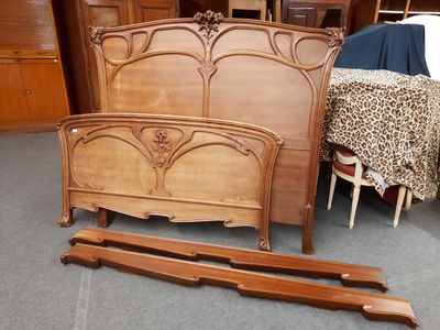 a bed with a wooden headboard and foot board in a room