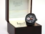 a black watch in a wooden box on a white surface