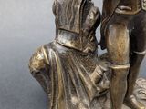 bronze figurine of a man and a woman with a dog