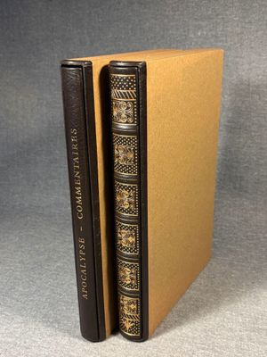 a brown book with a black cover sitting on top of a table