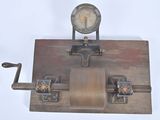 a clock that is on top of a piece of wood