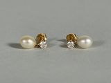 a pair of pearl and diamond earrings