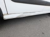 a white car with a black stripe on the side of it