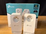 three tp - link tl - wpa230n powerline wi - fi extendr plugs on a table next to a box