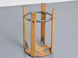 a wooden stand with a metal ring on top of it
