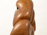 wooden sculpture of a man ' s torso on a white pedestal
