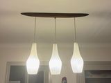 three lights that are hanging from the ceiling in the room