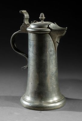 an old silver coffee pot with a bird on top of it