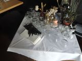 a table with a bunch of glasses and a book on it
