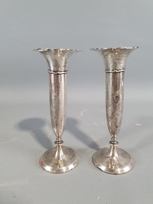 two silver candlesticks sitting on a table