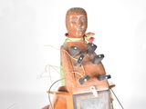 a statue of a man sitting on top of a chair