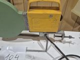 a yellow radio sitting on top of a table next to a black cord