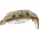 the back of a watch with a white face and brown leather strap