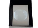 a picture of a picture of a glass sphere in a black box