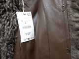 a brown leather jacket with a tag on it