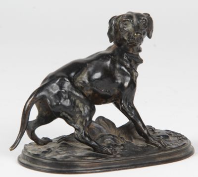 an image of a bronze statue of a dog sitting on top of a rock