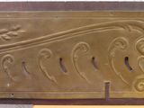 a close up of a metal object with a design on it