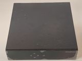 a black box that is sitting on a table next to a charger