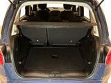 the back of a small blue car with the trunk open