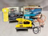 a yellow corded sander sitting on a table next to a box of power tools