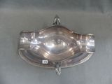 a silver plate with a handle hanging on the wall