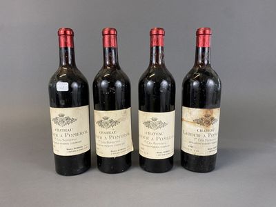 three bottles of red wine are lined up on a table