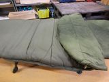 a sleeping bag that is on a table in a room