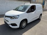 la camionnette blanche est garée dans un parking près d'un bâtiment