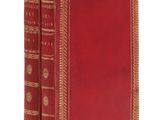 un vieux livre à la couverture rouge et à la bordure dorée