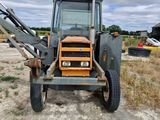 a tractor that is parked in the dirt