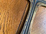 a metal cross on a wooden table on the floor