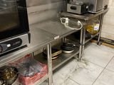 a kitchen with a stove, oven, sink, and other items on the counter