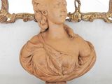 a bust of a woman sitting on a marble table