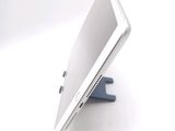 a tablet computer sitting on a stand on a white surface