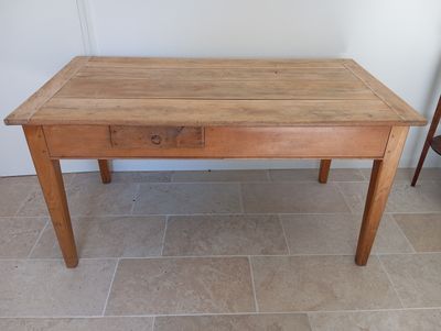 a small wooden table with a drawer on it