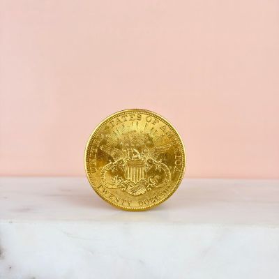 a gold coin sitting on top of a marble counter top