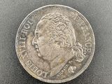 a close up of a silver coin on a black surface