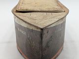 an old wooden box with writing on it sitting on a white surface
