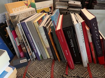 une pile de livres posée par terre à côté d'une autre pile de livres