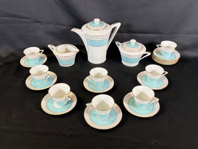 many cups and saucers arranged in a circle on a table