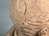 a clay statue of a man with a hat on his head