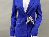 the mannequin is wearing a blue jacket and black pants