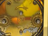 a close up of a gold clock with a clock face