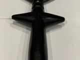 a black object hanging on the wall next to a white wall