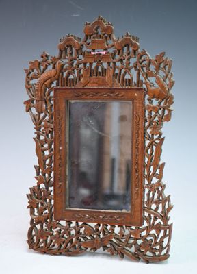 a wooden frame with a bird and flower design on it