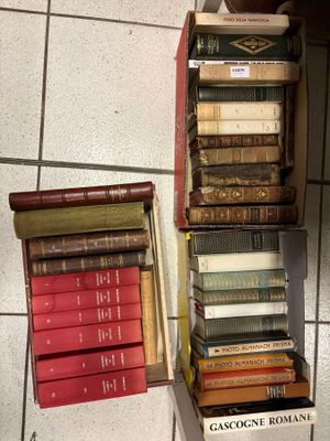 many books stacked on top of each other on a shelf