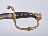 an old sword with a gold handle on a white background