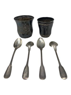 five spoons and two cups sitting next to each other