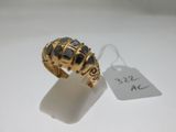une image représentant une bague en or sertie de pierres noires sur un fond blanc
